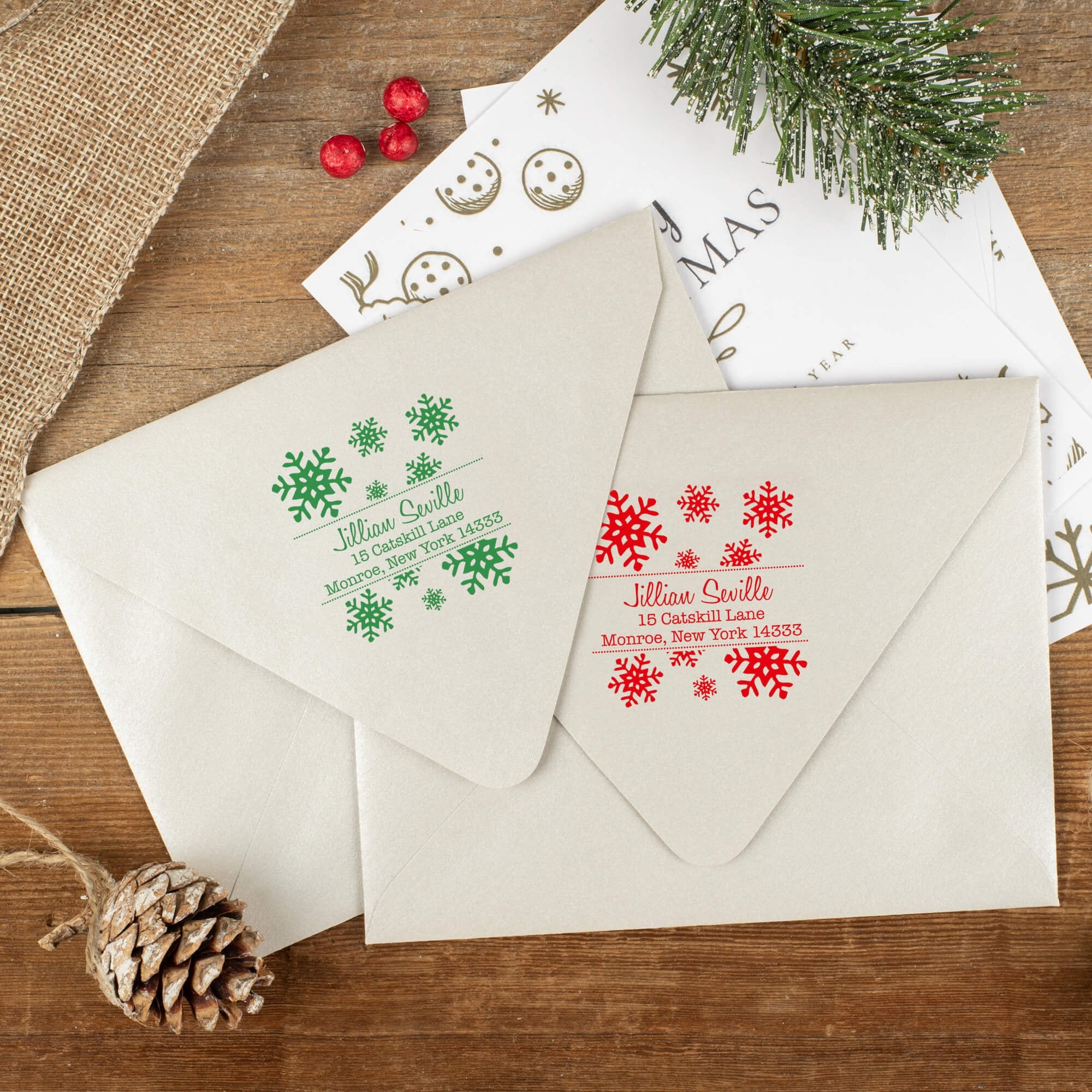 Green and red ink impressions of ‘Seville Snowflakes’ return address stamp on Christmas envelopes.