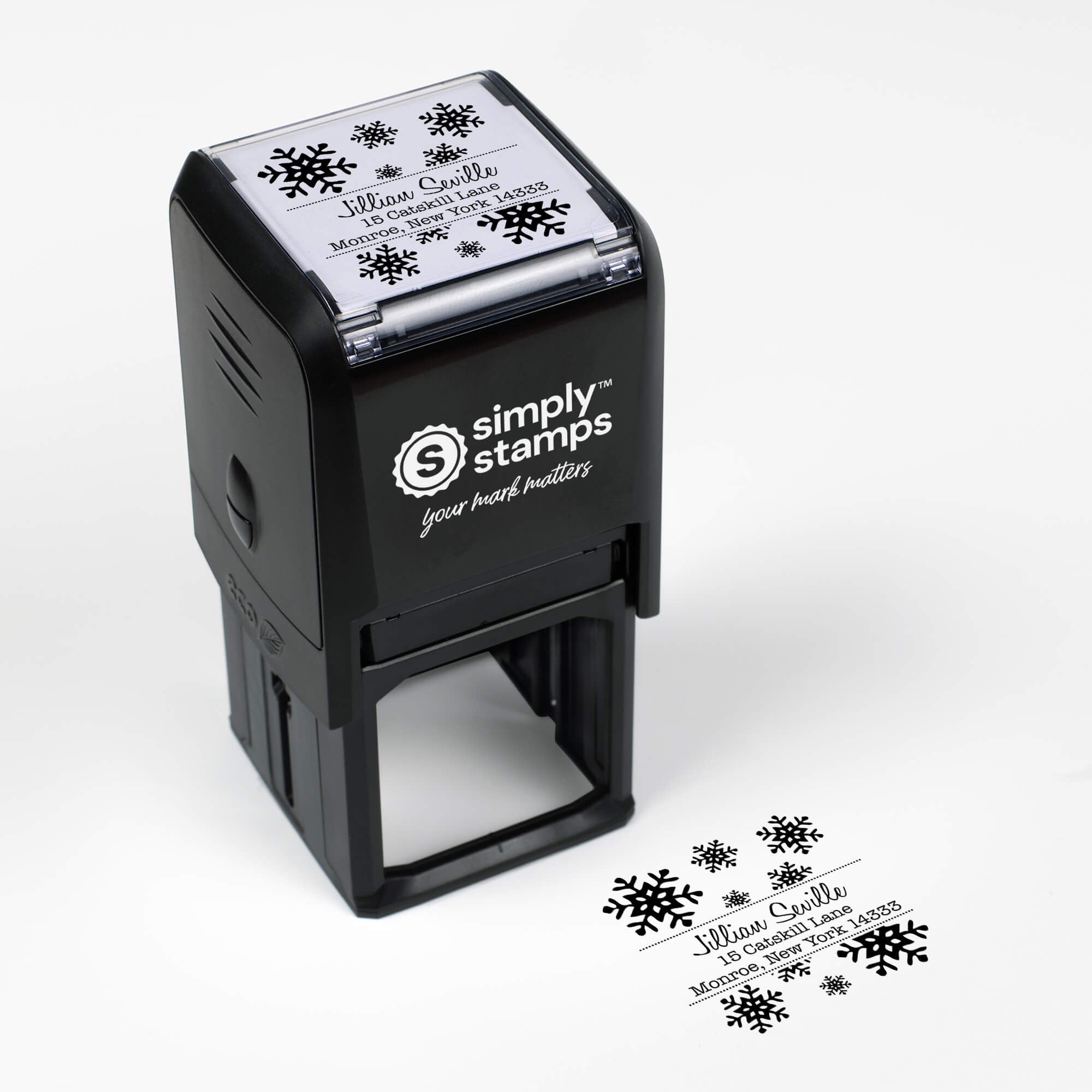 Top angle view of self-inking holiday stamp with circular ‘Seville Snowflakes’ address design.