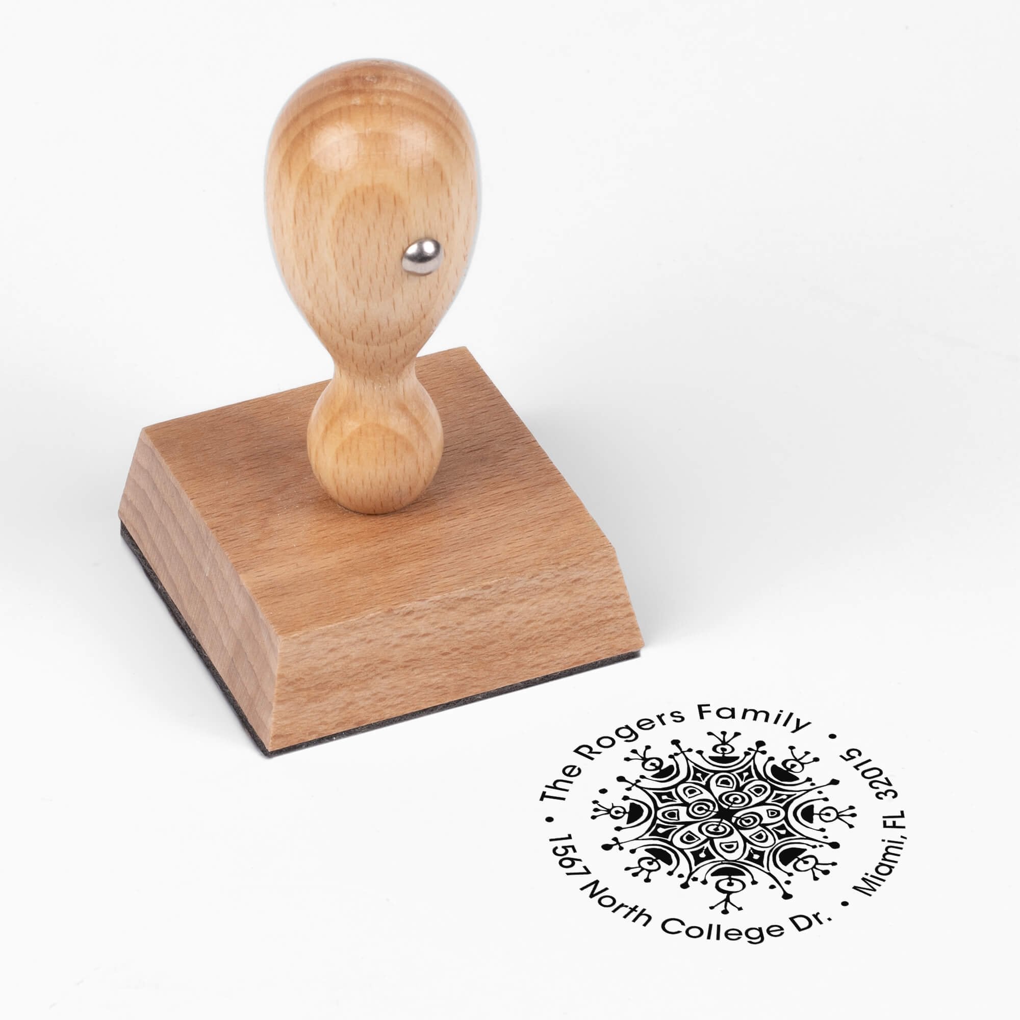 European wood hand stamp shown from above featuring custom ‘Rogers Ornament Round’ holiday return address design.