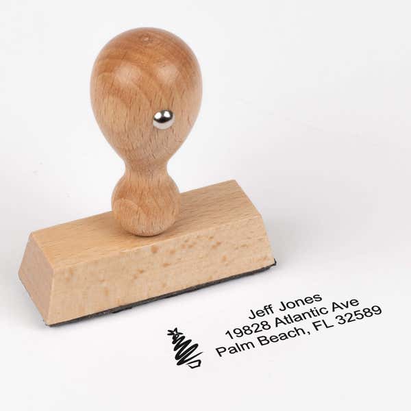 European wood hand stamp shown from above featuring custom ‘Holiday Custom Icon’ holiday return address design.