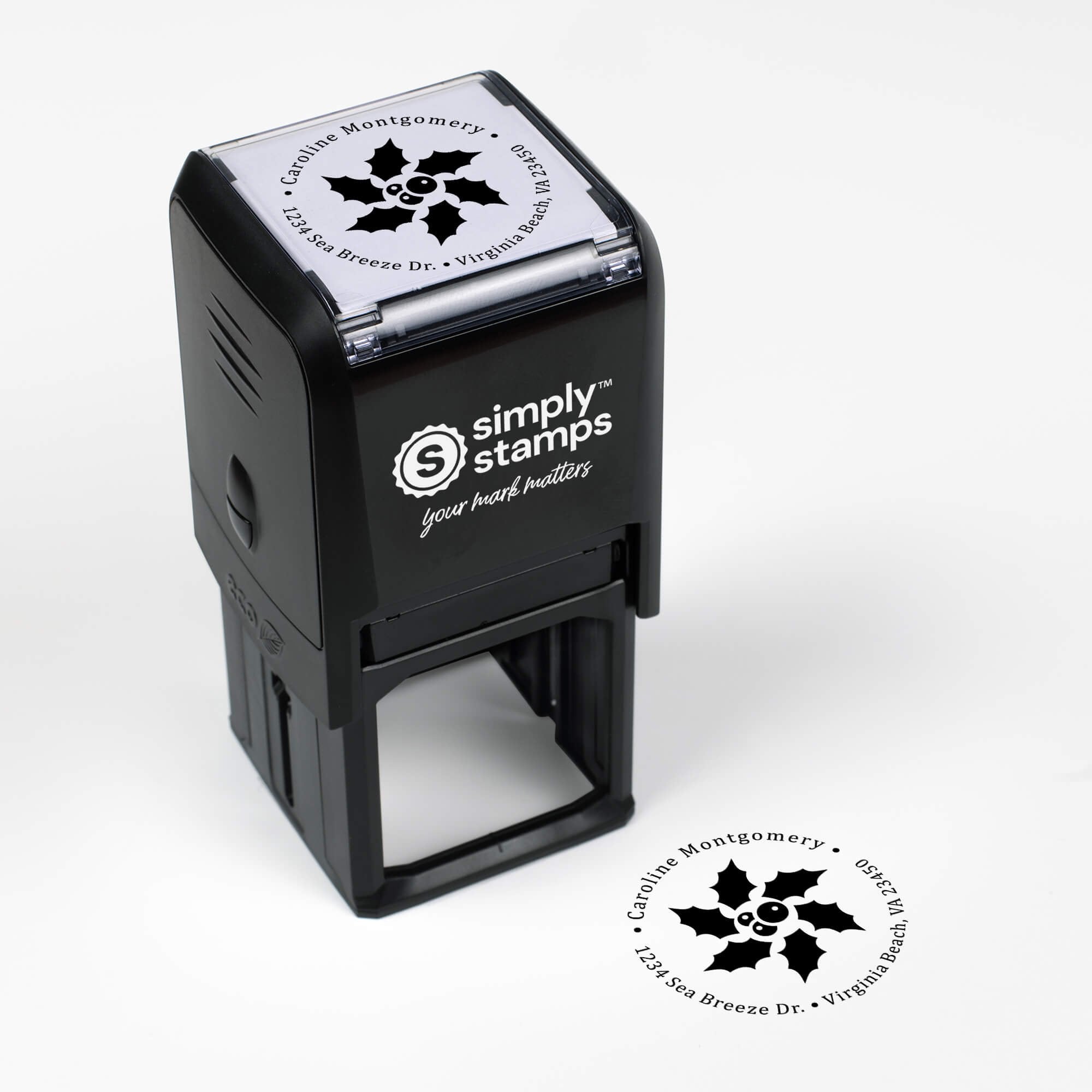 Top angle view of self-inking holiday stamp with circular ‘Star Holly’ address design.