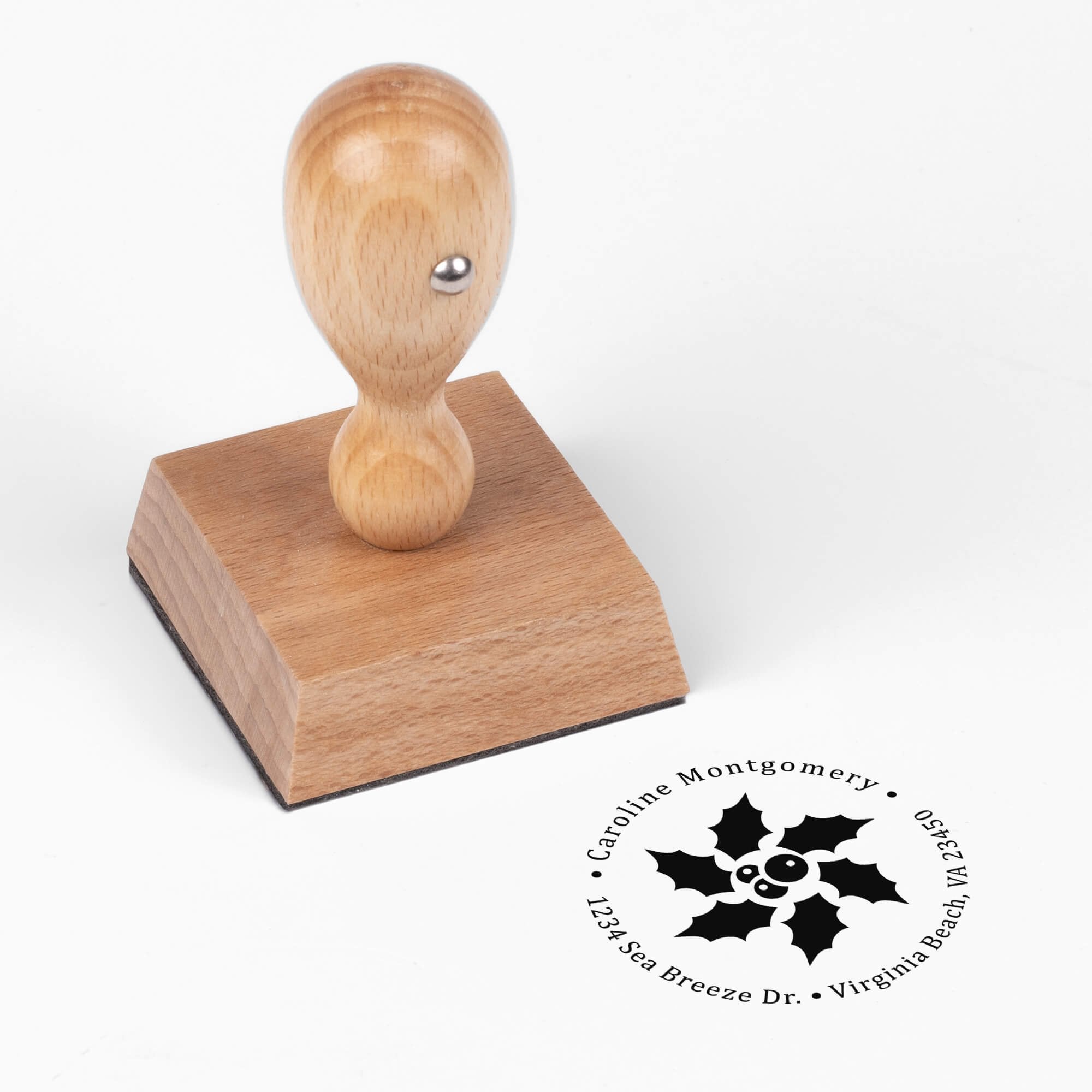 European wood hand stamp shown from above featuring custom ‘Star Holly’ holiday return address design.