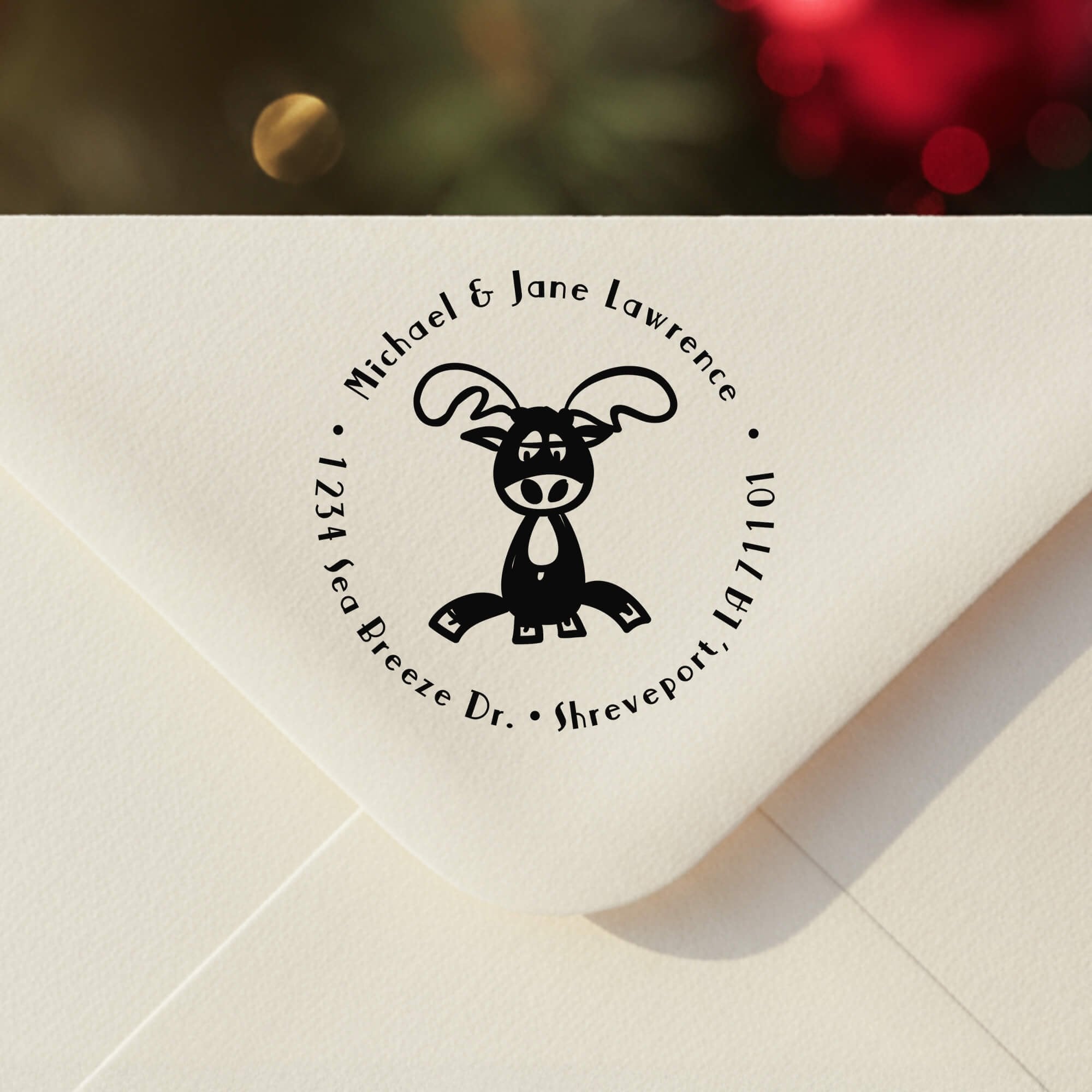 Personalized ‘Lazy Reindeer’ address stamp impression on envelope flap for holiday cards.