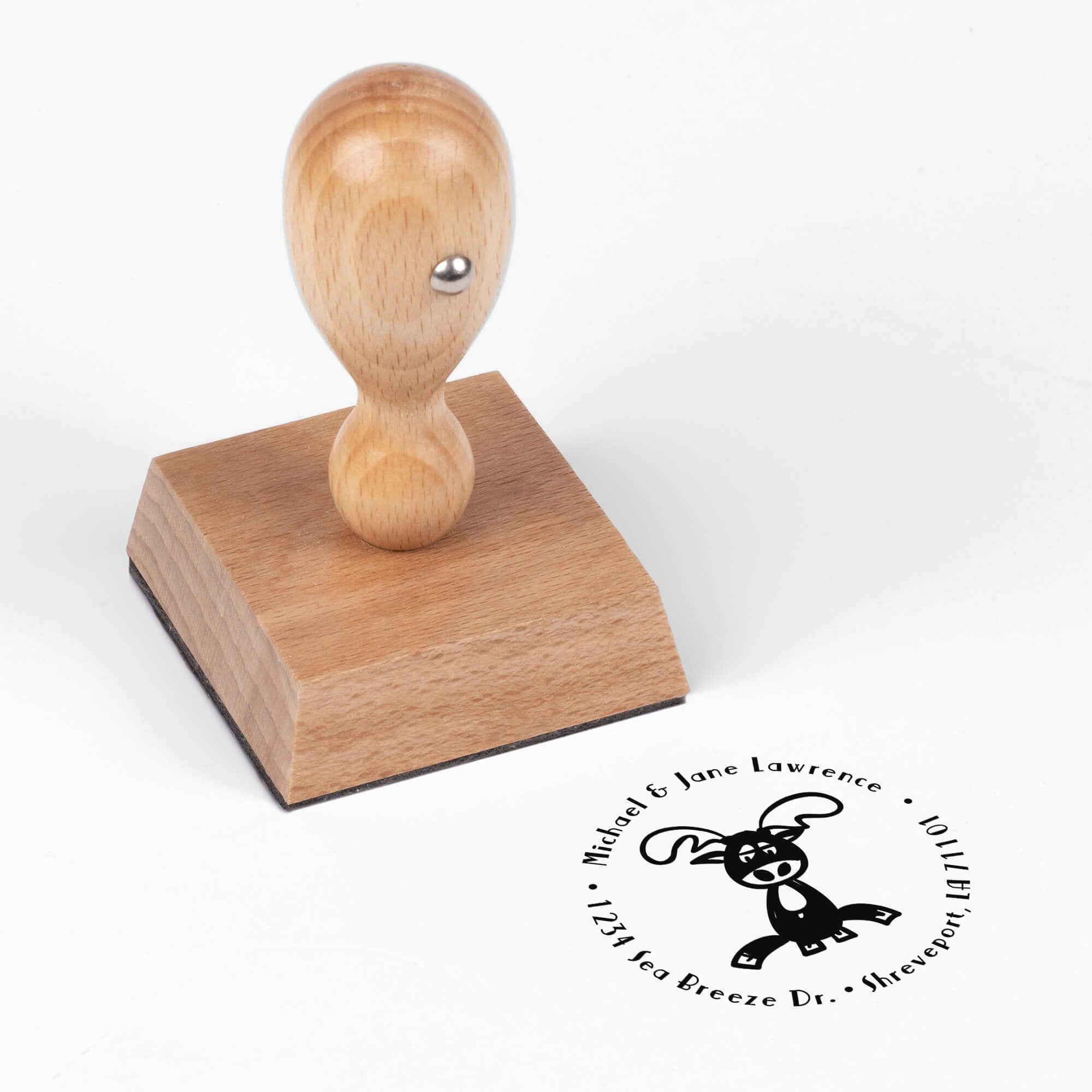 European wood hand stamp shown from above featuring custom ‘Lazy Reindeer’ holiday return address design.
