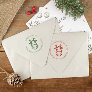 Green and red ink impressions of ‘Geometric Reindeer’ return address stamp on Christmas envelopes.