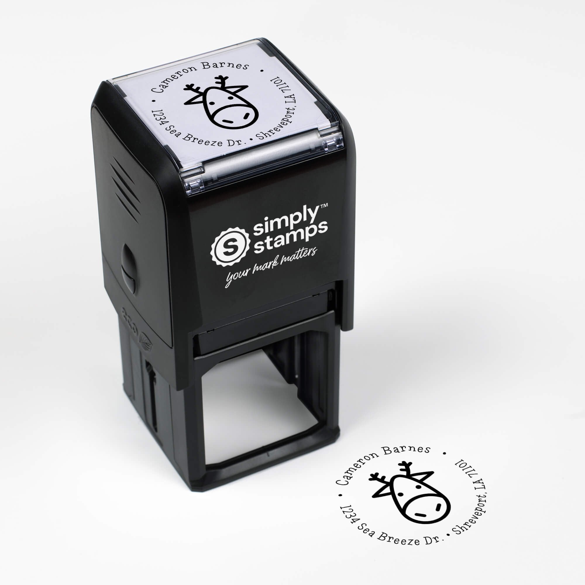 Top angle view of self-inking holiday stamp with circular ‘Geometric Reindeer’ address design.