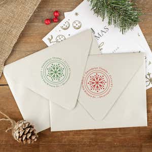 Green and red ink impressions of ‘Dotted Snowflake’ return address stamp on Christmas envelopes.