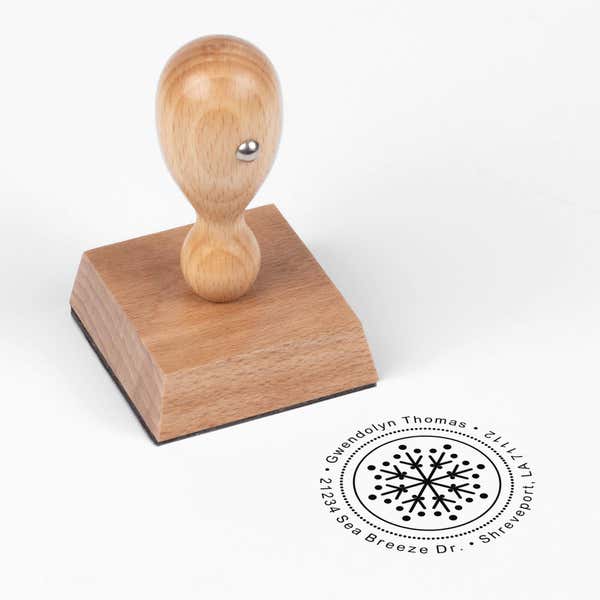 European wood hand stamp shown from above featuring custom ‘Dotted Snowflake’ holiday return address design.