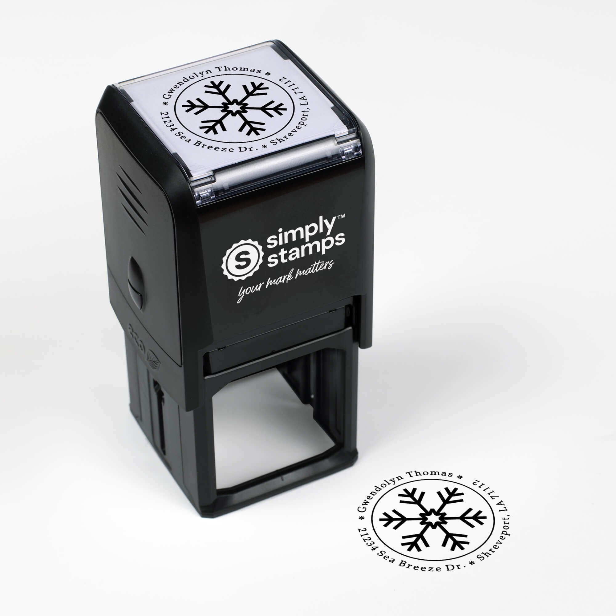 Top angle view of self-inking holiday stamp with circular ‘Six Point Snowflake’ address design.