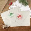 Green and red ink impressions of ‘Scarved Snowman’ return address stamp on Christmas envelopes.