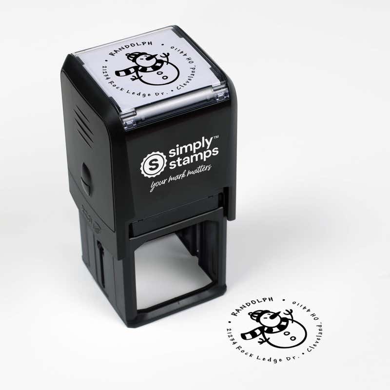 Top angle view of self-inking holiday stamp with circular ‘Scarved Snowman’ address design.
