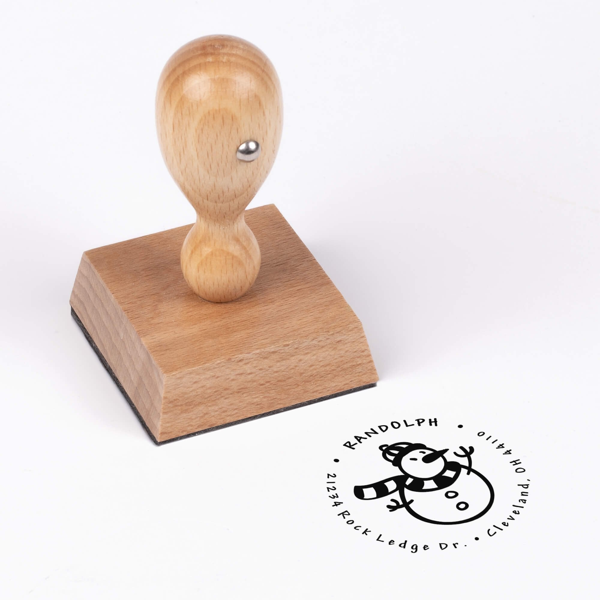 European wood hand stamp shown from above featuring custom ‘Six Point Snowflake’ holiday return address design.