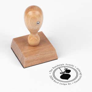 European wood hand stamp shown from above featuring custom ‘Randolph Christmas Ornaments’ holiday return address design.
