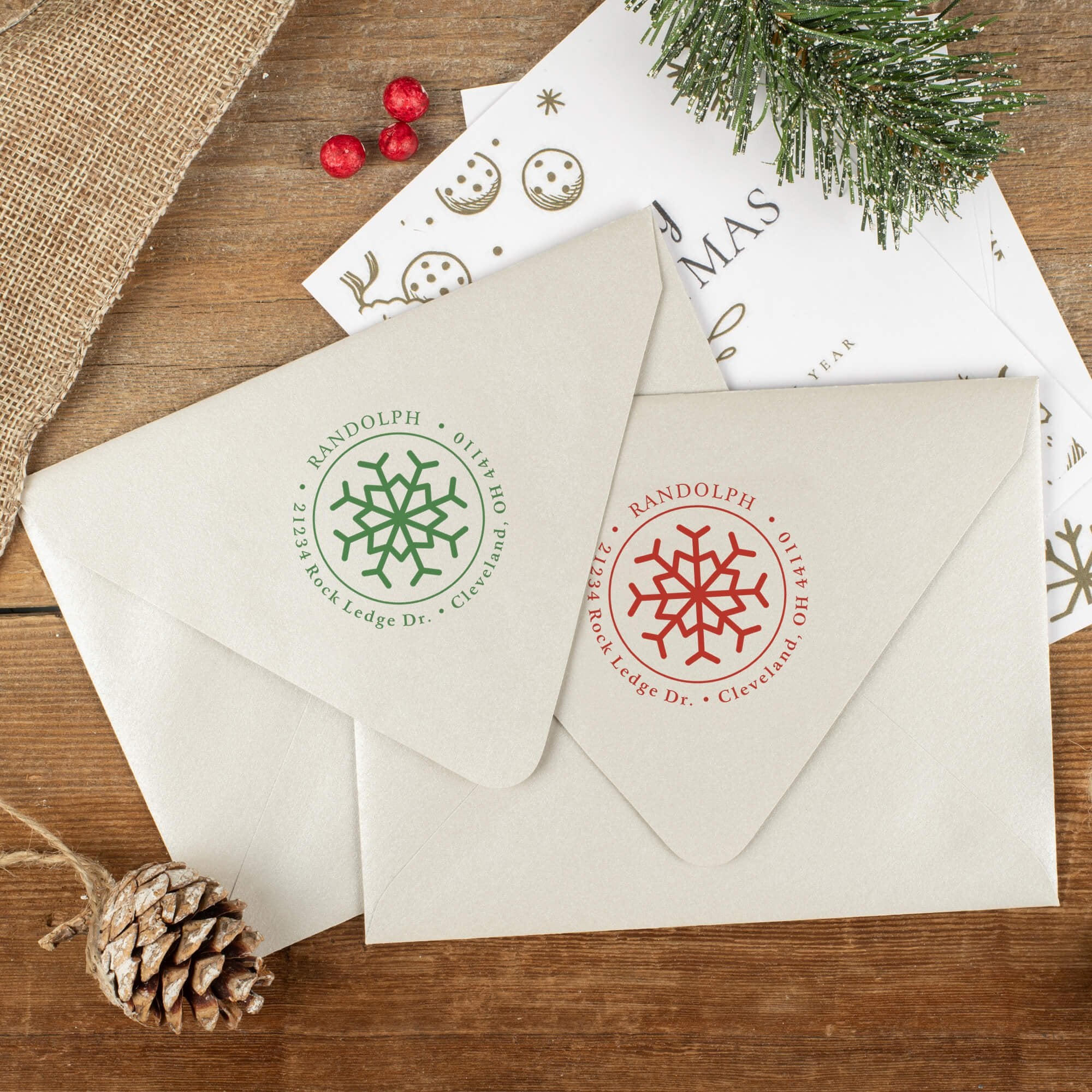 Green and red ink impressions of ‘Eight Point Snowflake’ return address stamp on Christmas envelopes.