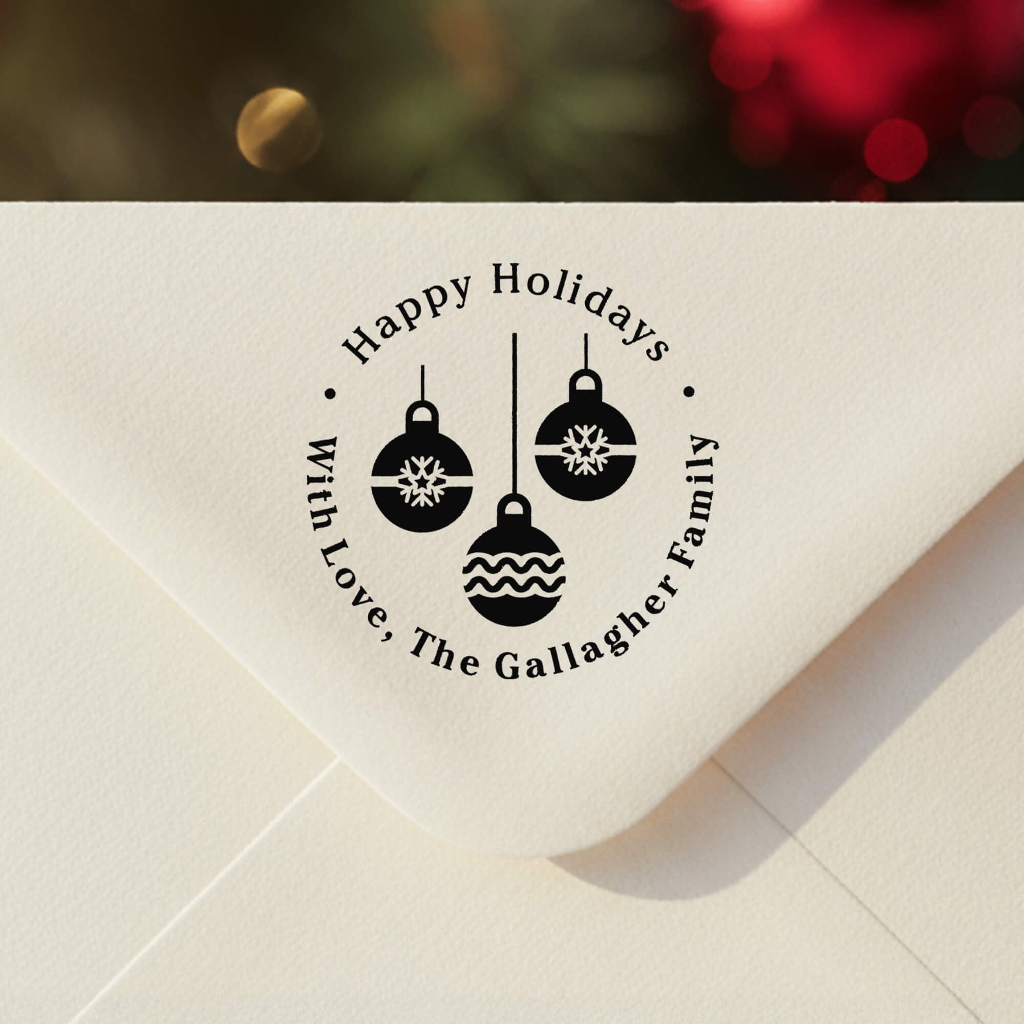 Personalized ‘Three Christmas Ornaments’ address stamp impression on envelope flap for holiday cards.