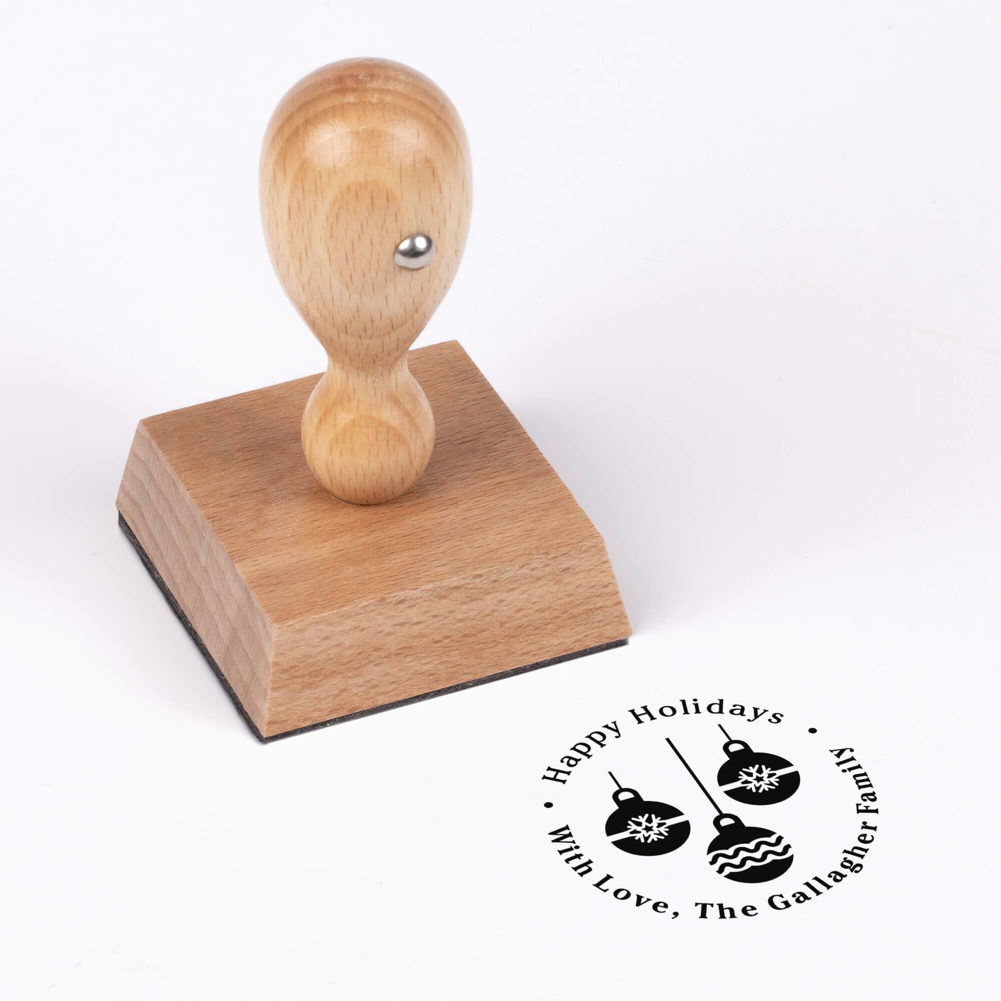 European wood hand stamp shown from above featuring custom ‘Three Christmas Ornaments’ holiday return address design.