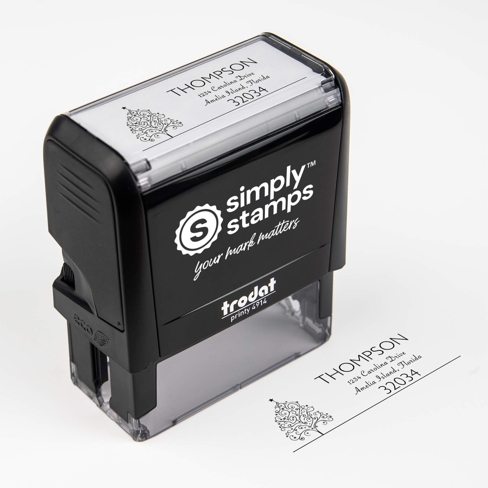 Top angle view of self-inking holiday stamp with circular ‘Curly Christmas Tree’ address design.
