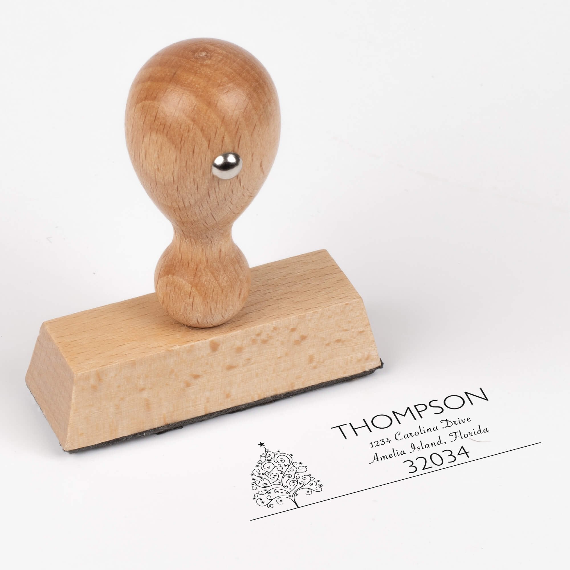 European wood hand stamp shown from above featuring custom ‘Curly Christmas Tree’ holiday return address design.