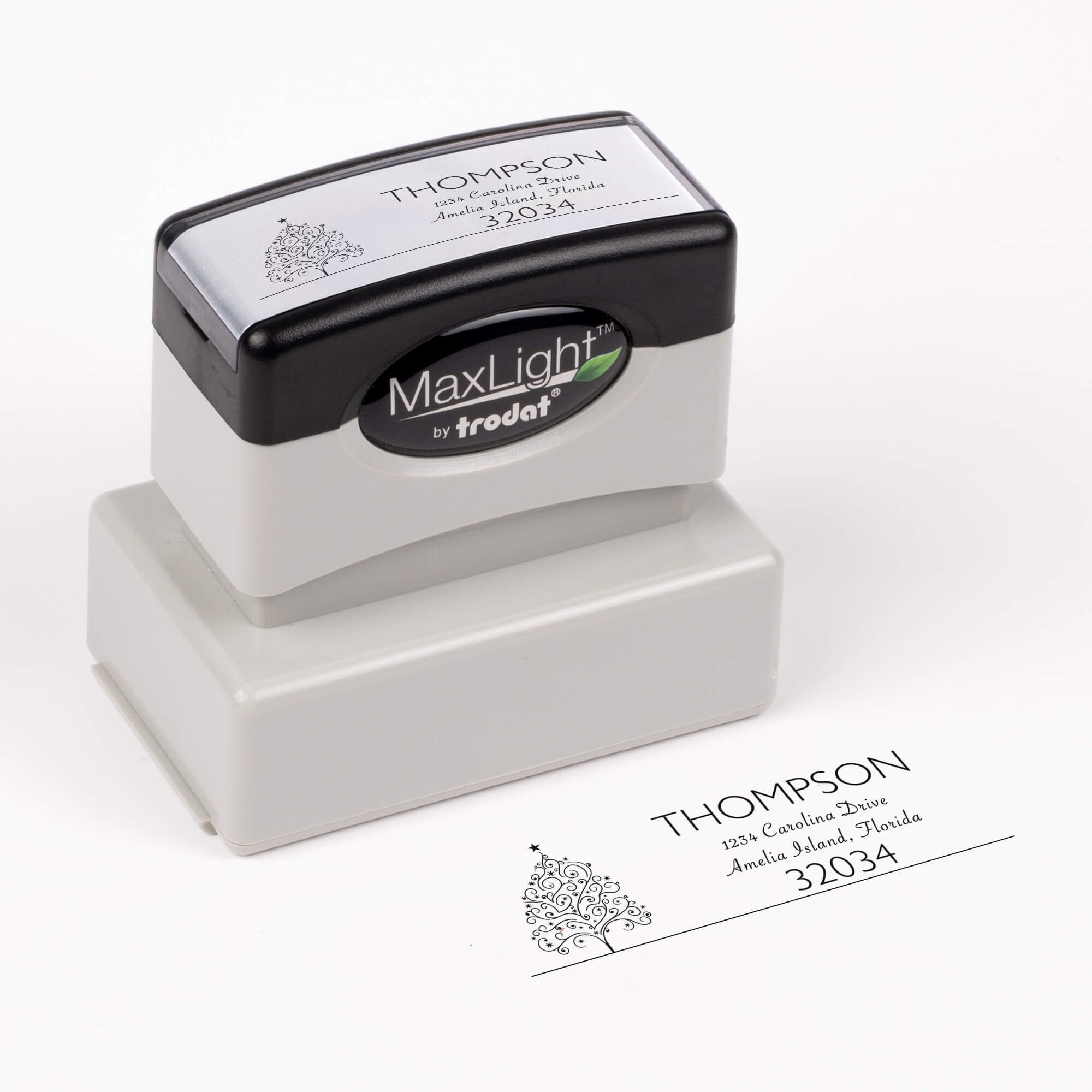 Pre-inked stamp shown from above featuring custom ‘Curly Christmas Tree’  holiday return address design.