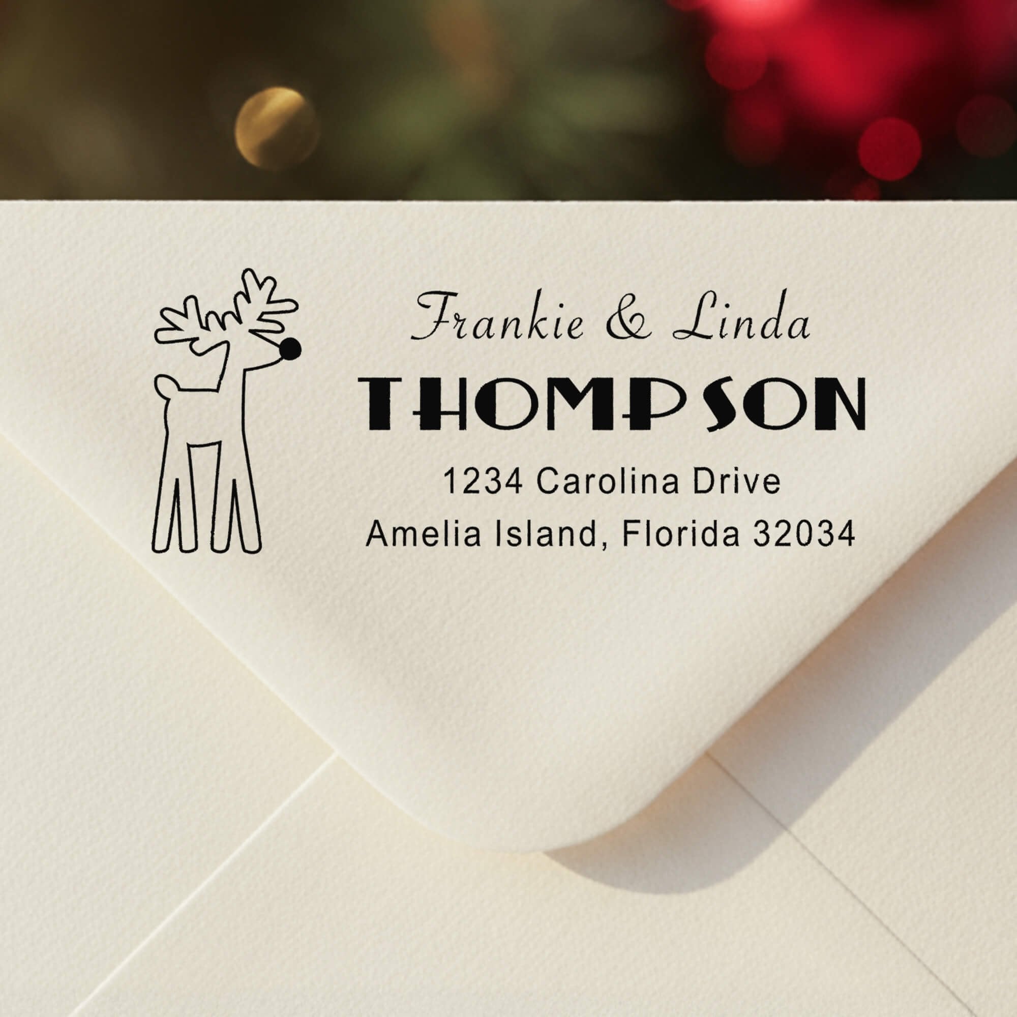 Personalized ‘Rudolph Reindeer’ address stamp impression on envelope flap for holiday cards.