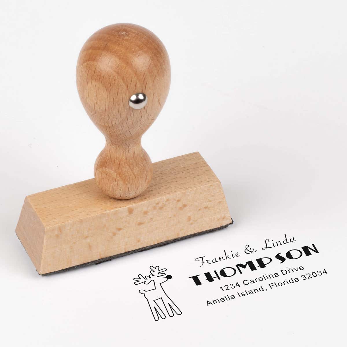 European wood hand stamp shown from above featuring custom ‘Rudolph Reindeer’ holiday return address design.