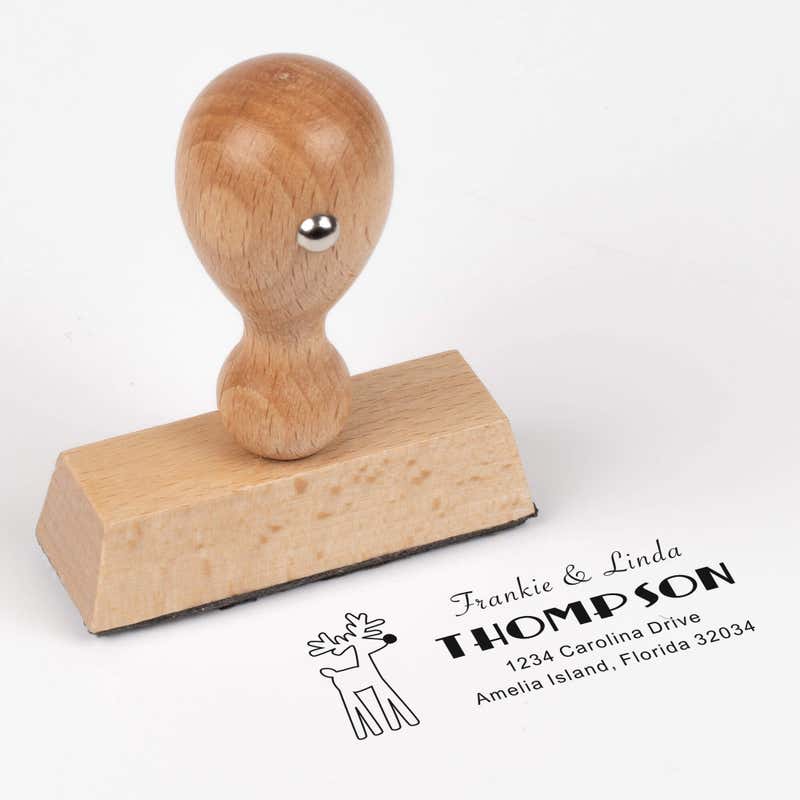 European wood hand stamp shown from above featuring custom ‘Rudolph Reindeer’ holiday return address design.