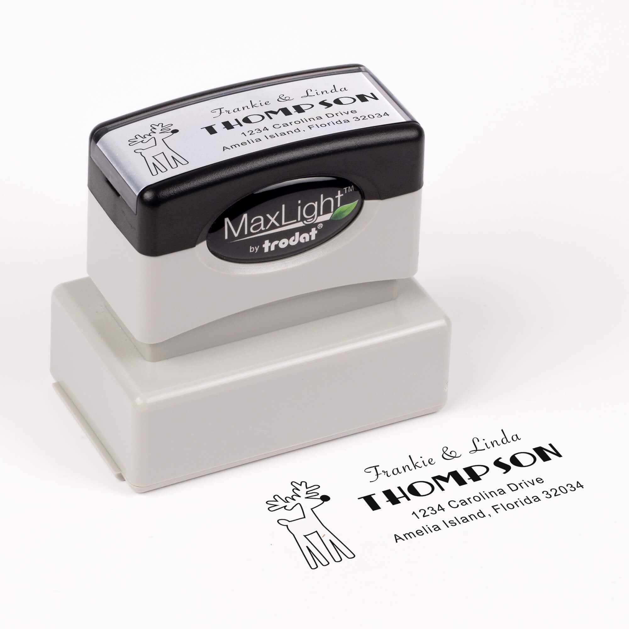 Pre-inked stamp shown from above featuring custom ‘Rudolph Reindeer’  holiday return address design.