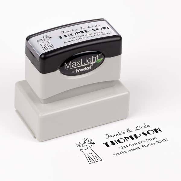 Pre-inked stamp shown from above featuring custom ‘Rudolph Reindeer’  holiday return address design.