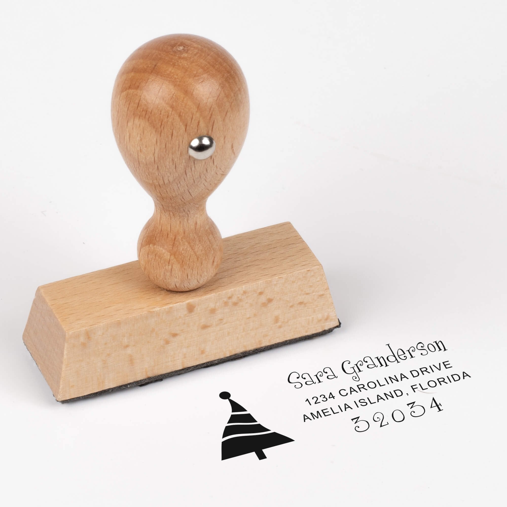 European wood hand stamp shown from above featuring custom ‘Dancing Christmas Tree’ holiday return address design.