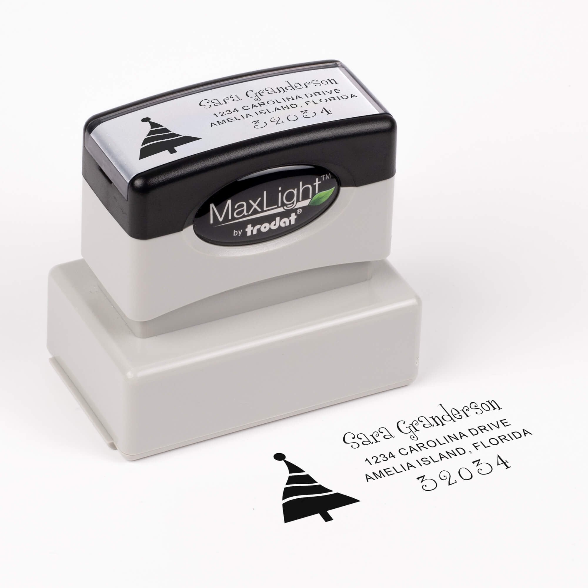 Pre-inked stamp shown from above featuring custom ‘Dancing Christmas Tree’  holiday return address design.