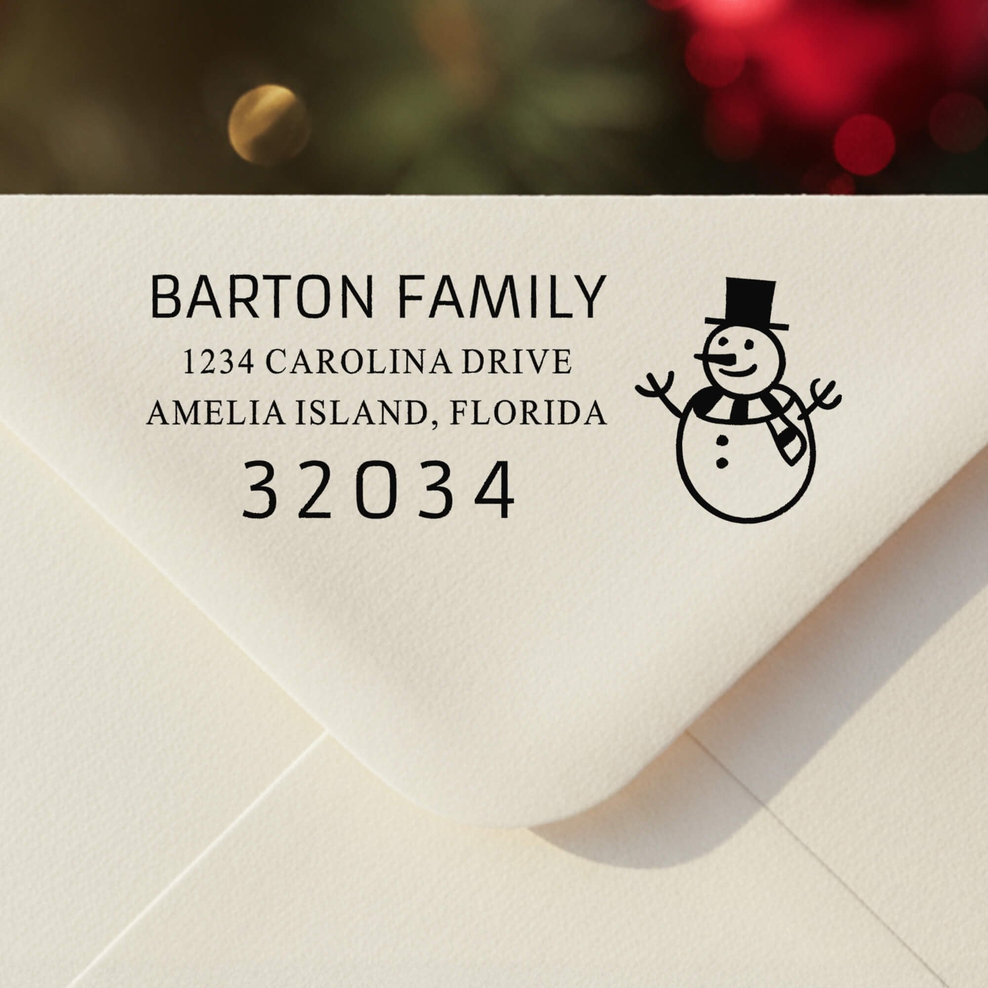 Personalized ‘Snowman’ address stamp impression on envelope flap for holiday cards.