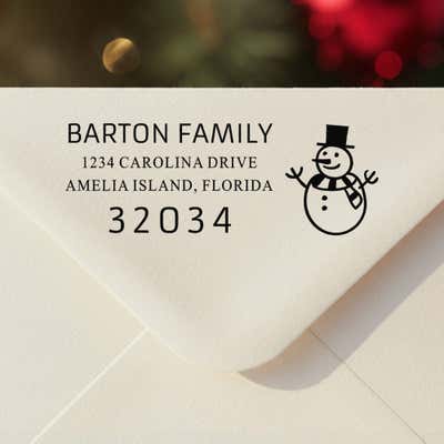 Personalized ‘Snowman’ address stamp impression on envelope flap for holiday cards.