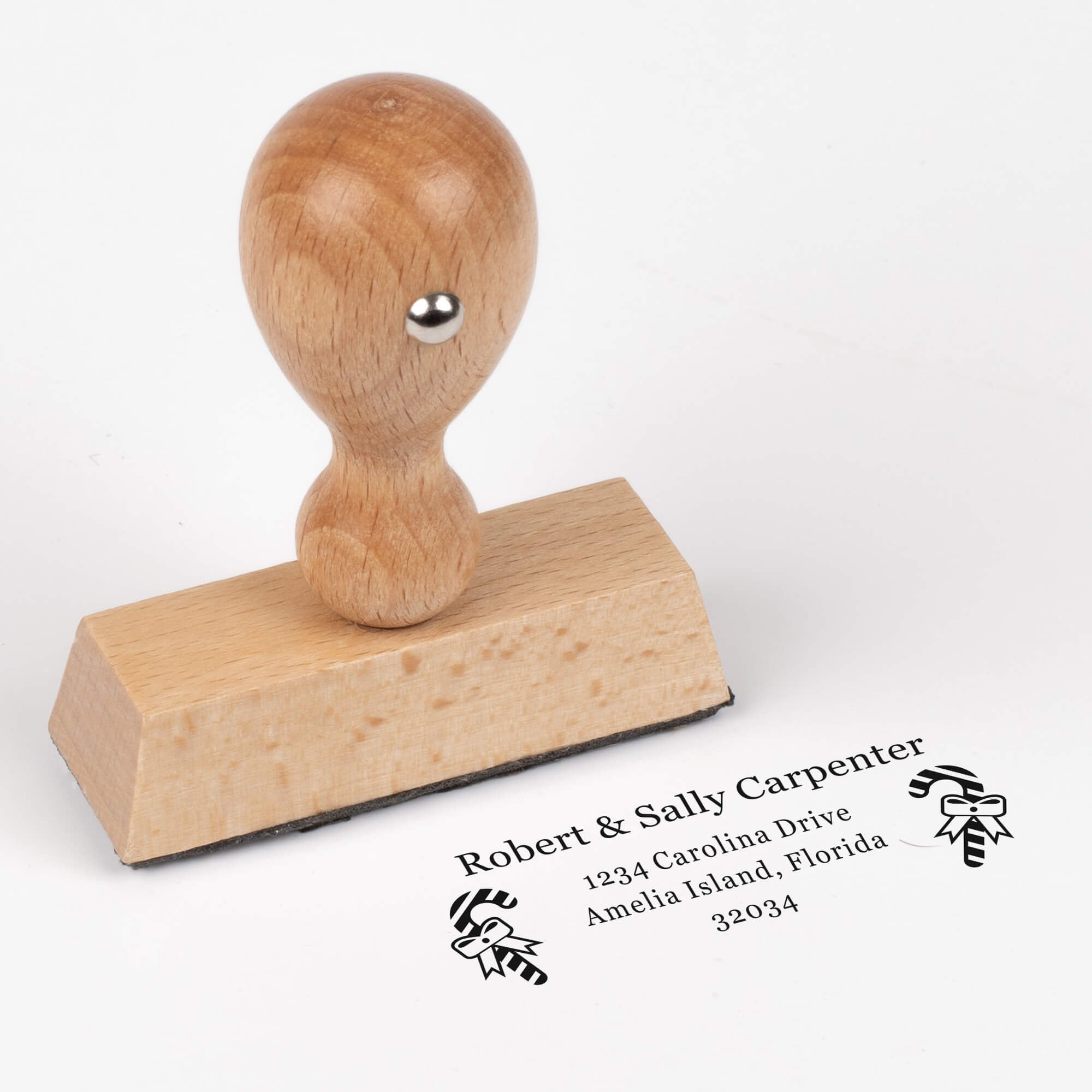 European wood hand stamp shown from above featuring custom ‘Carpenter Candy Cane’ holiday return address design.