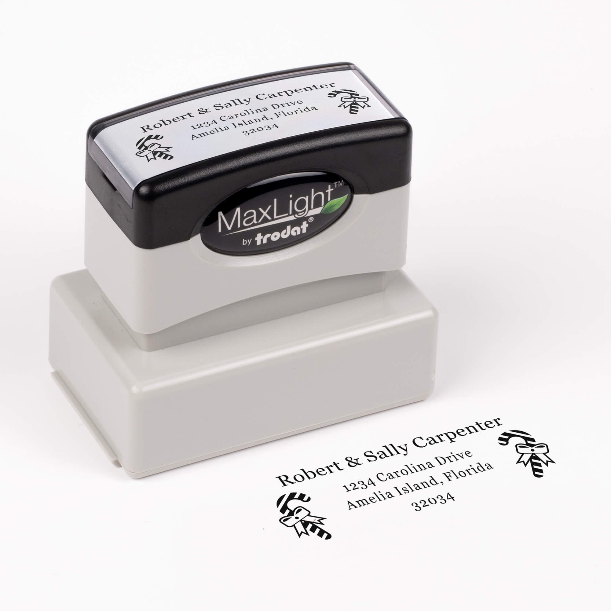 Pre-inked stamp shown from above featuring custom ‘Carpenter Candy Cane’  holiday return address design.