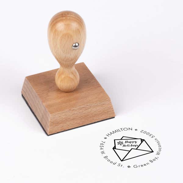 European wood hand stamp shown from above featuring custom ‘Happy Holidays Card’ holiday return address design.