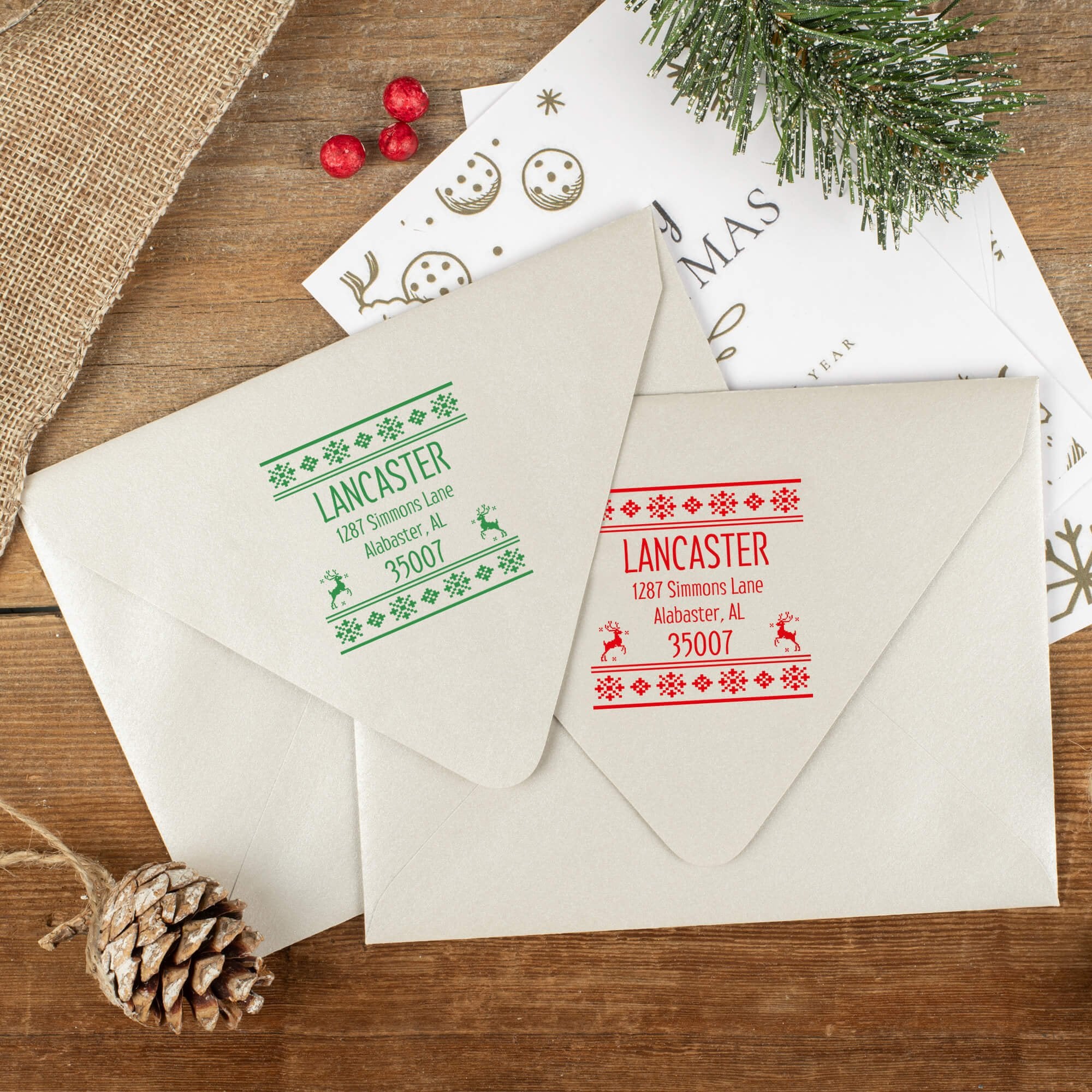 Green and red ink impressions of ‘Designer Reindeer’ return address stamp on Christmas envelopes.