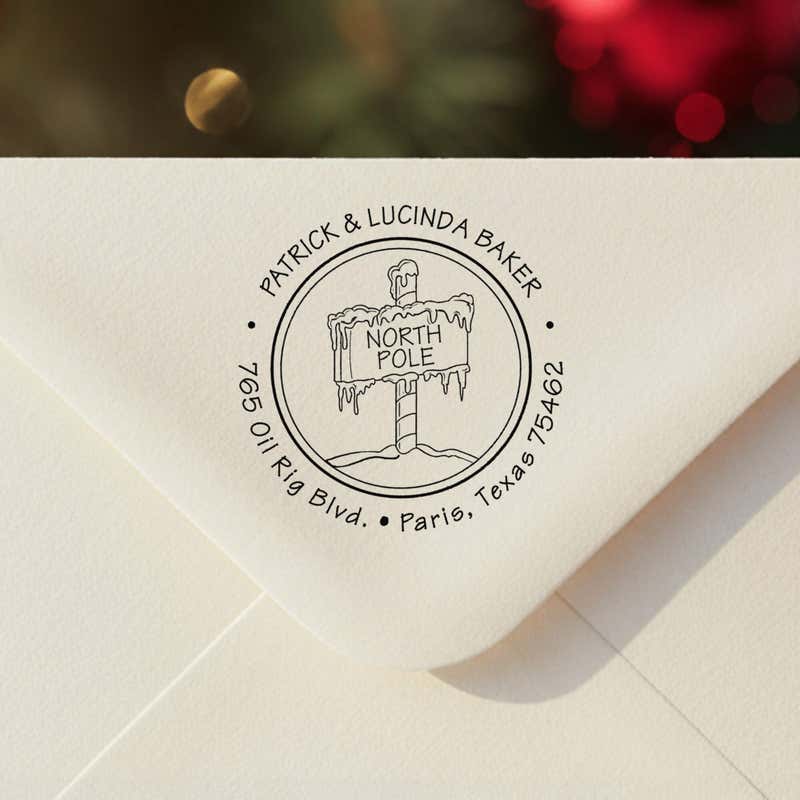 Personalized ‘North Pole’ address stamp impression on envelope flap for holiday cards.