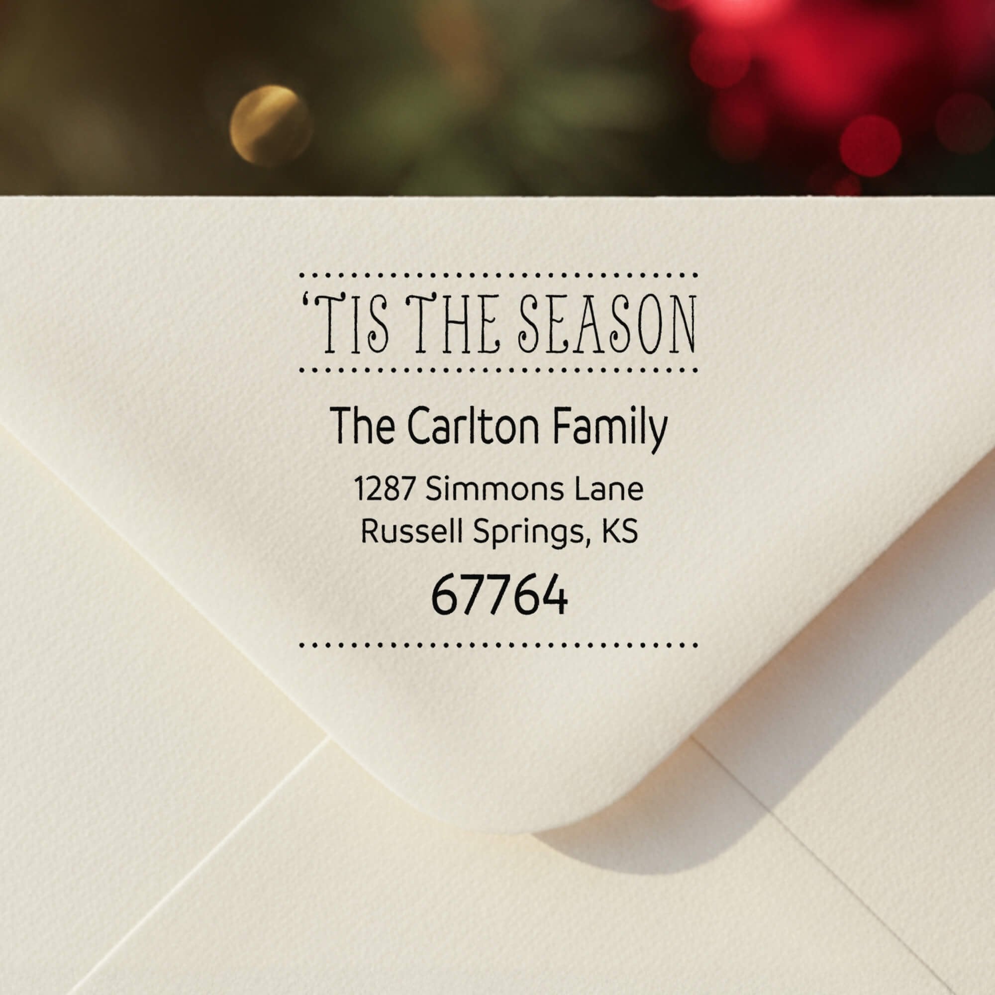 Personalized ‘Tis The Season’ address stamp impression on envelope flap for holiday cards.