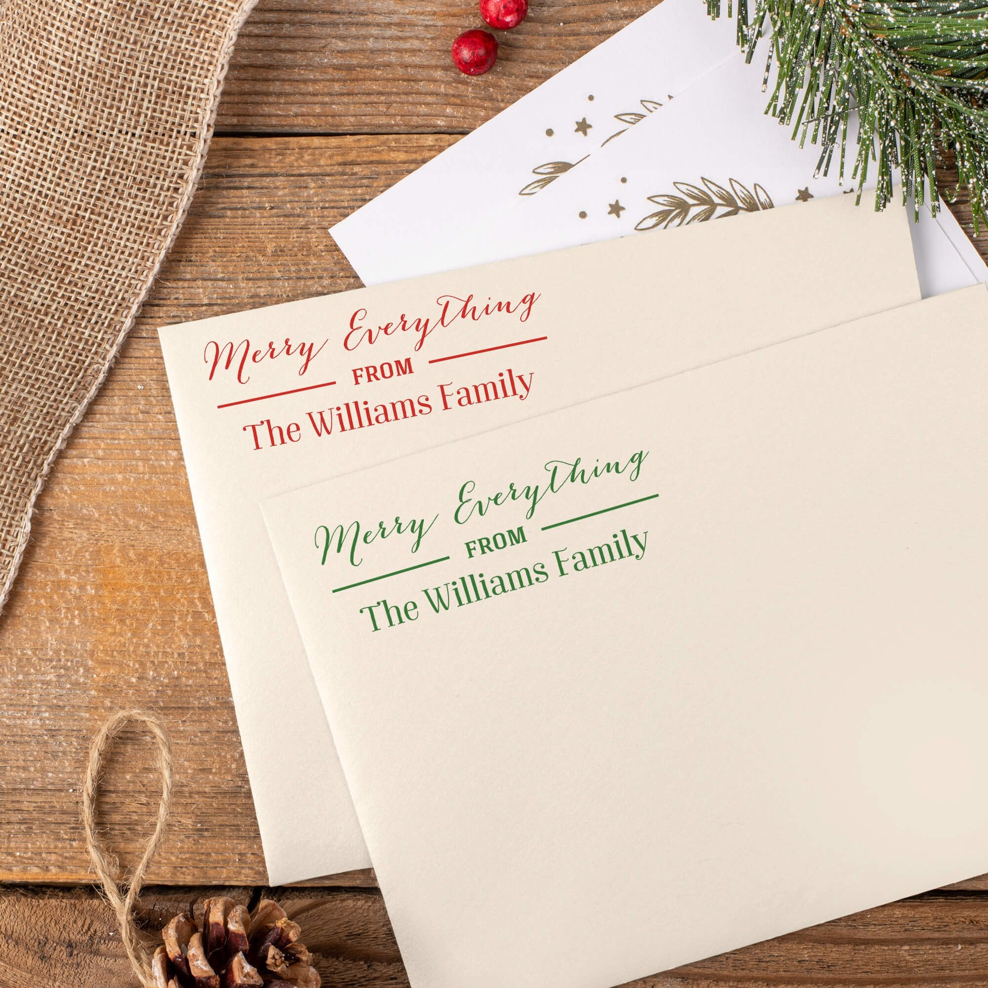 Green and red ink impressions of ‘Merry Everything’ return address stamp on Christmas envelopes.