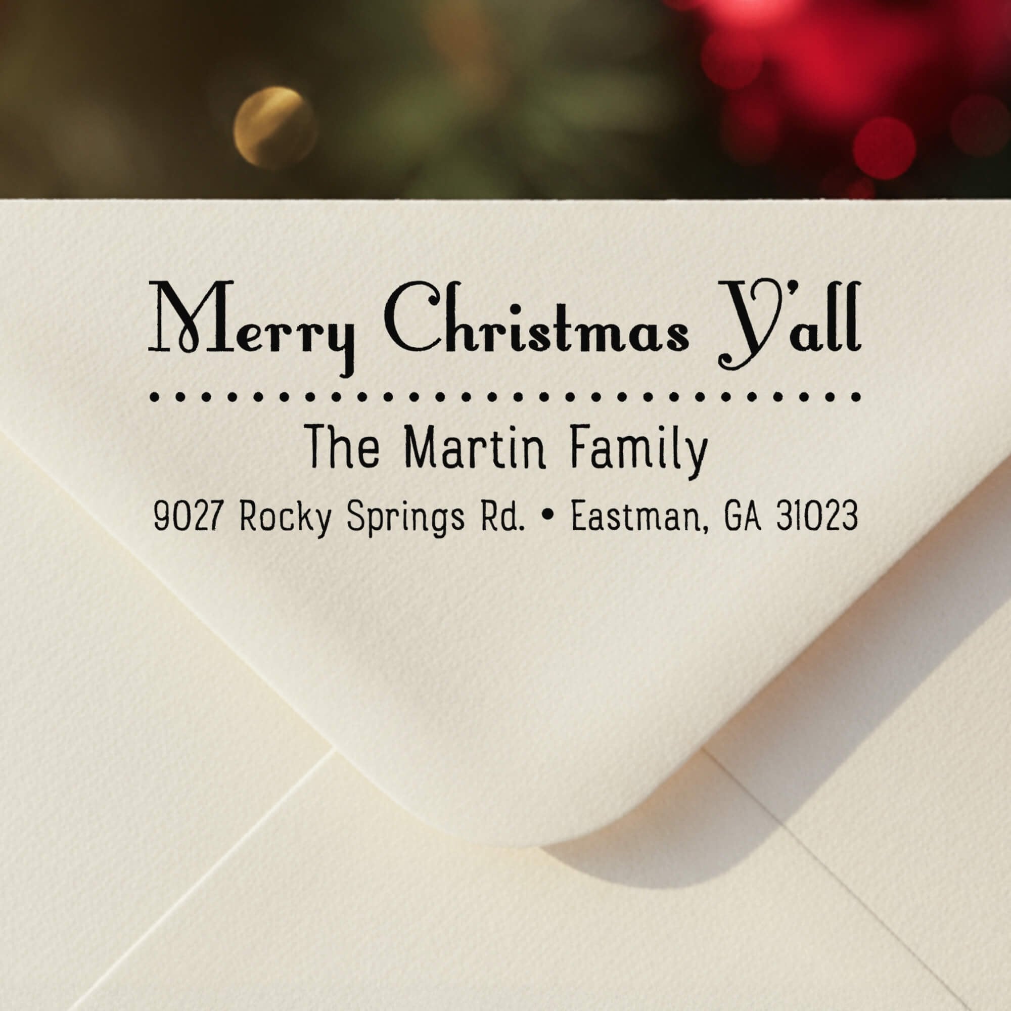 Personalized ‘Merry Christmas Y’all’ address stamp impression on envelope flap for holiday cards.