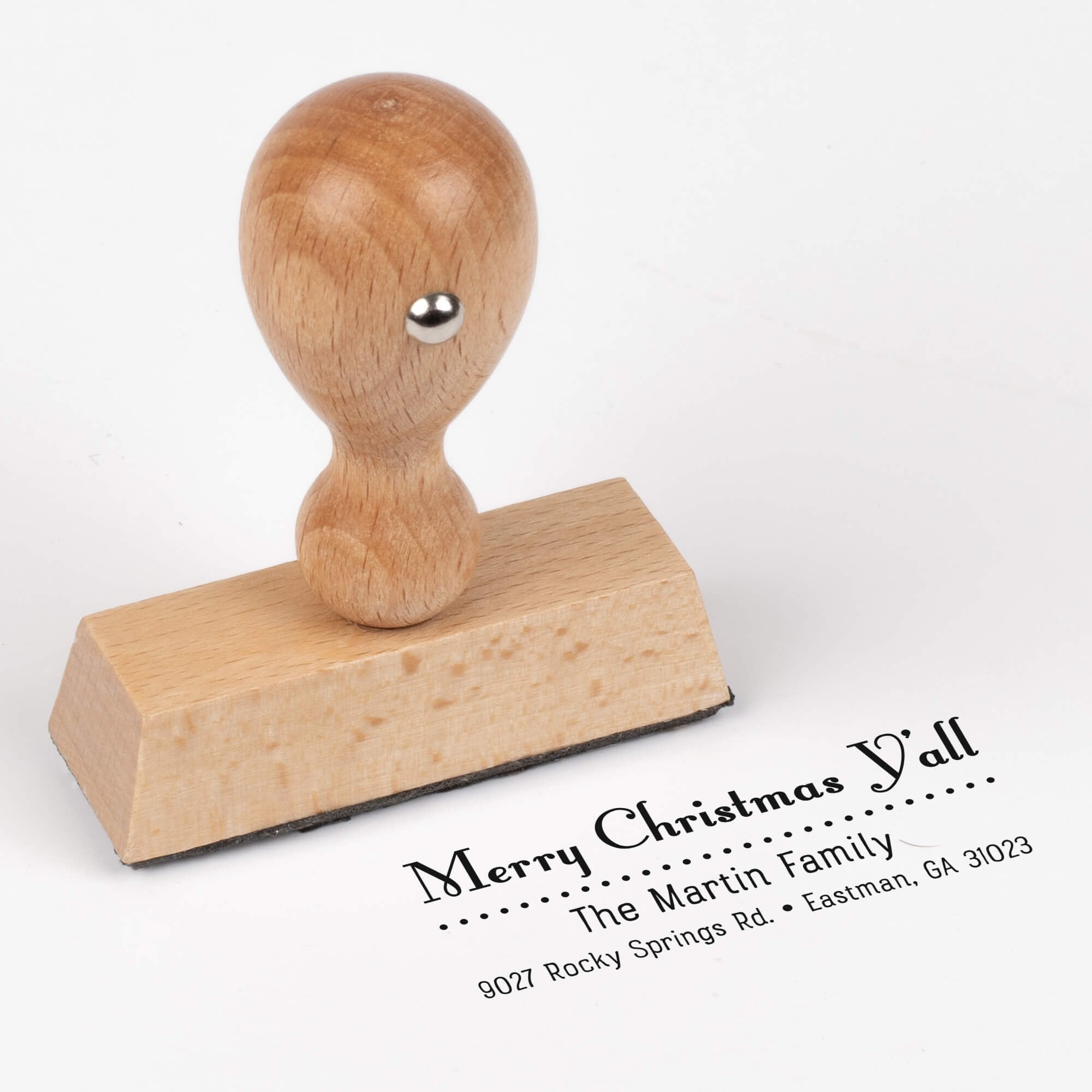 European wood hand stamp shown from above featuring custom ‘Merry Christmas Y’all’ holiday return address design.