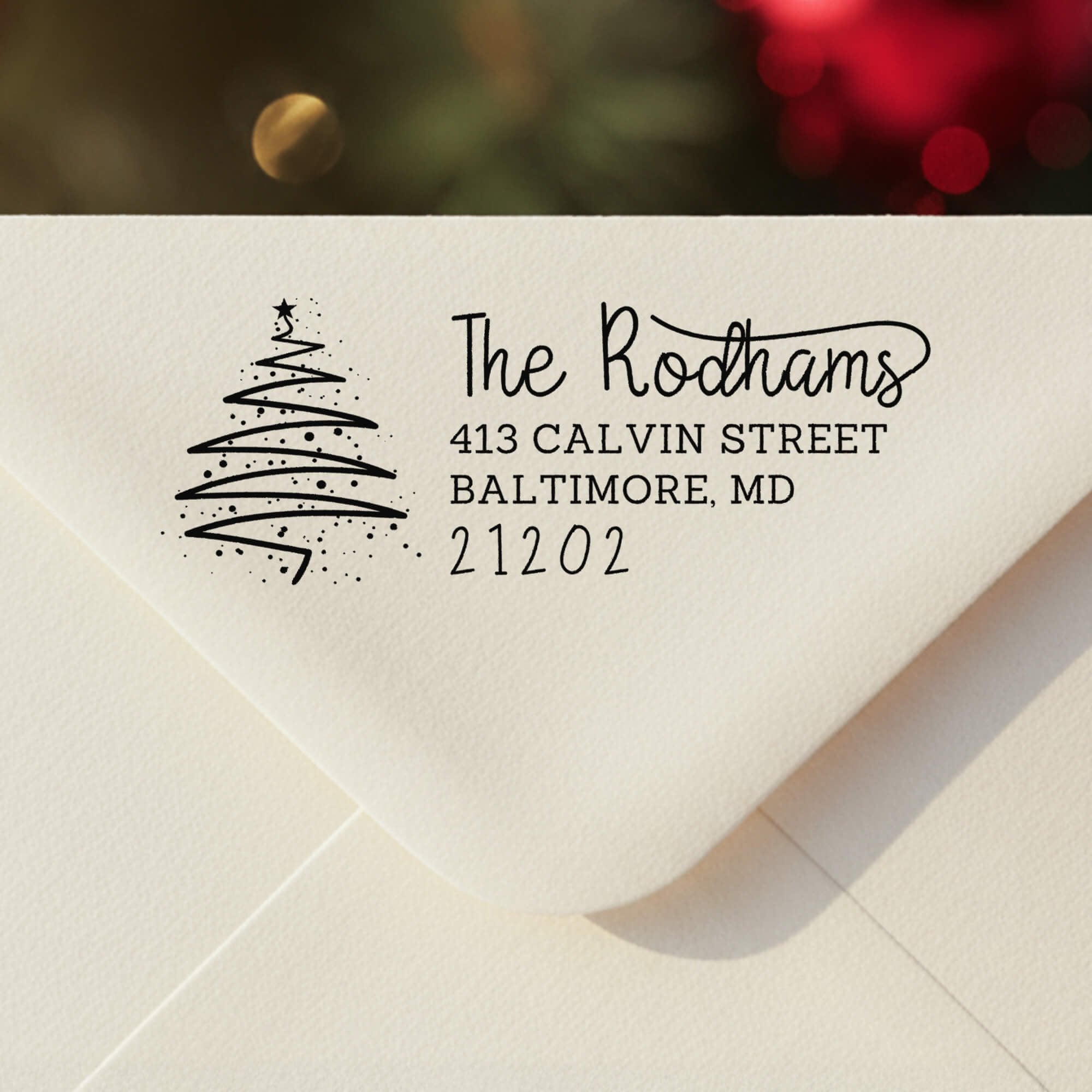 Personalized ‘Rodham Script Christmas Tree’ address stamp impression on envelope flap for holiday cards.