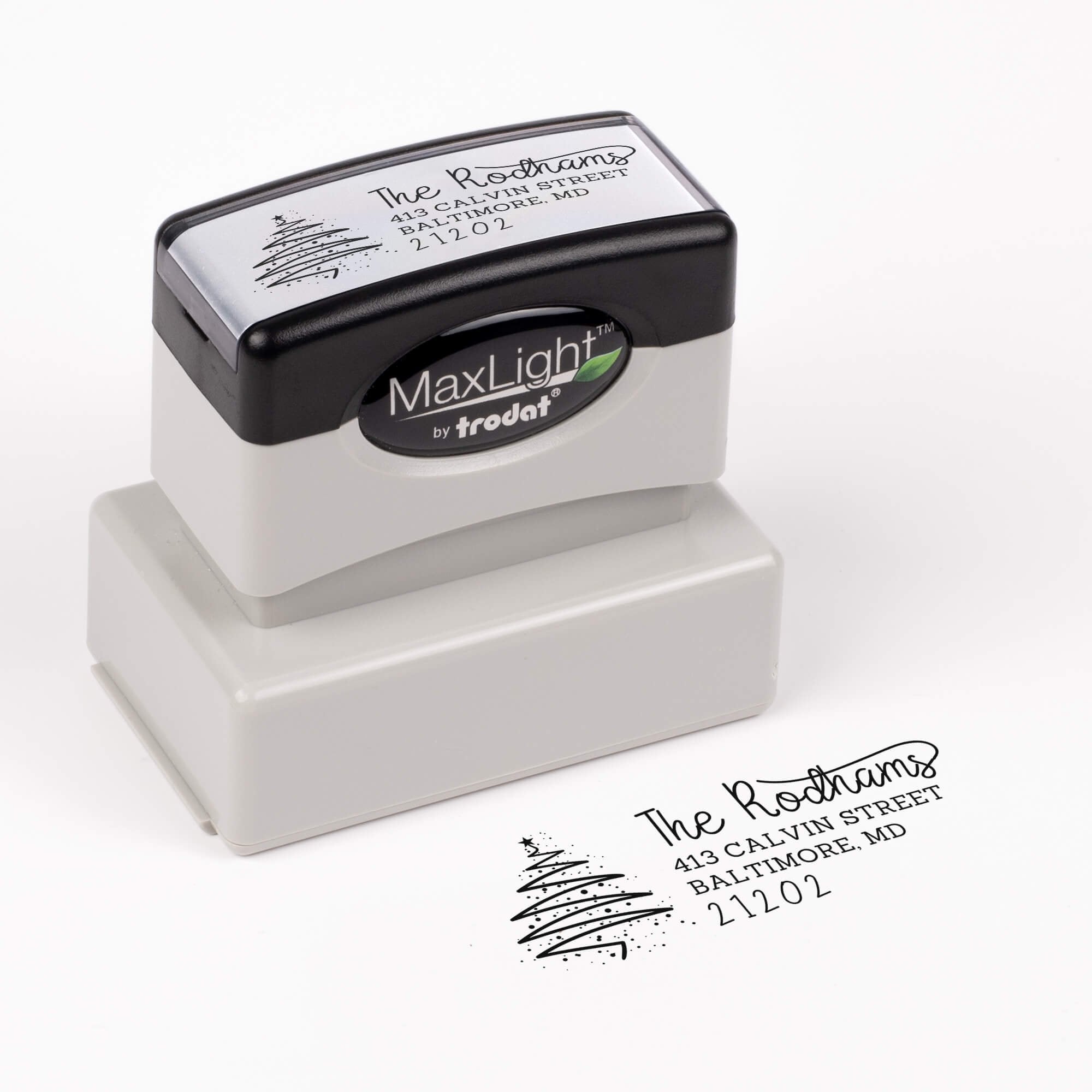 Pre-inked stamp shown from above featuring custom ‘Rodham Script Christmas Tree’  holiday return address design.