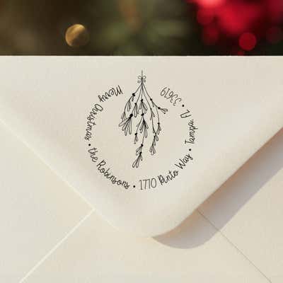 Personalized ‘Mistletoe Round Script’ address stamp impression on envelope flap for holiday cards.