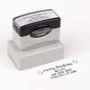 Pre-inked stamp shown from above featuring custom ‘Merry Christmas Decorative Swirl’  holiday return address design.
