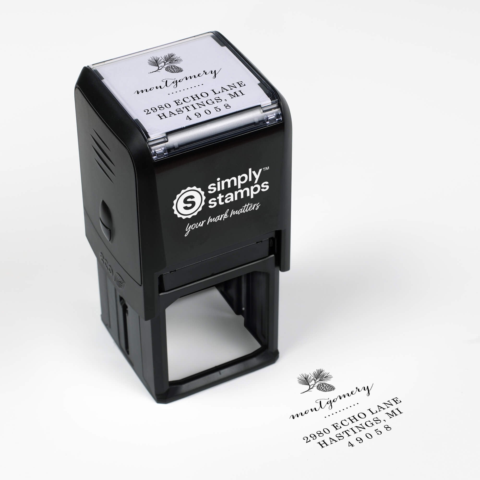 Top angle view of self-inking holiday stamp with circular ‘Montgomery Pine Winter’ address design.