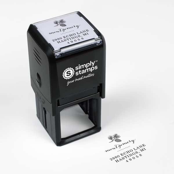 Top angle view of self-inking holiday stamp with circular ‘Montgomery Pine Winter’ address design.
