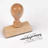 European wood hand stamp shown from above featuring custom ‘Montgomery Trendy’ holiday return address design.