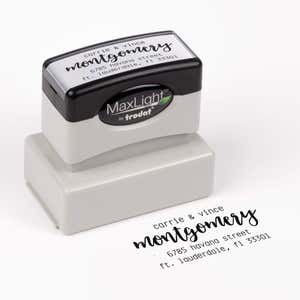 Pre-inked stamp shown from above featuring custom ‘Montgomery Trendy’  holiday return address design.