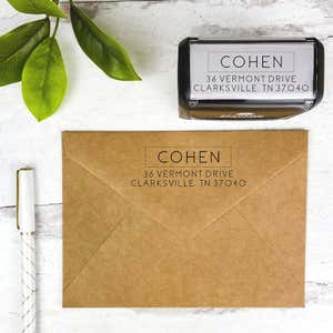 An example of the Thin San Serif Address Stamp impression on brown paper